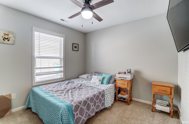 bedroom featuring visible vents, a ceiling fan, baseboards, and carpet floors