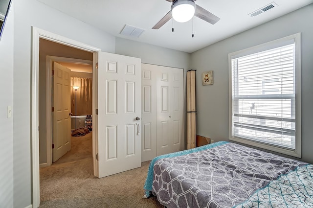 bedroom featuring a ceiling fan, carpet, visible vents, and a closet