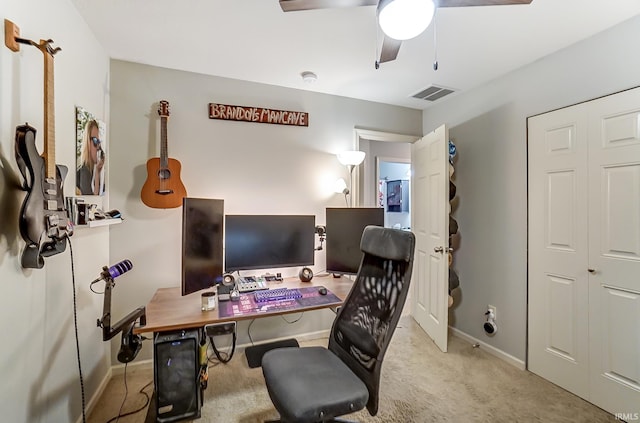 home office with visible vents, carpet floors, baseboards, and a ceiling fan