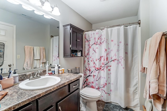 bathroom featuring a shower with shower curtain, visible vents, toilet, and vanity