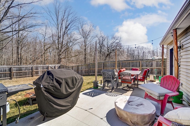 view of patio featuring a fenced backyard, area for grilling, and outdoor dining space