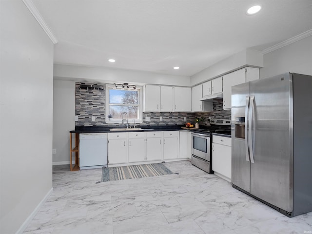 kitchen featuring dark countertops, backsplash, marble finish floor, stainless steel appliances, and a sink