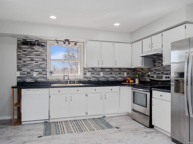 kitchen with marble finish floor, a sink, under cabinet range hood, white cabinetry, and appliances with stainless steel finishes