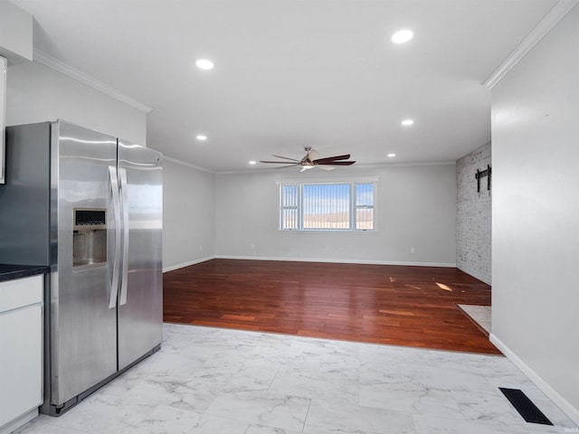 kitchen featuring ornamental molding, visible vents, stainless steel refrigerator with ice dispenser, and ceiling fan