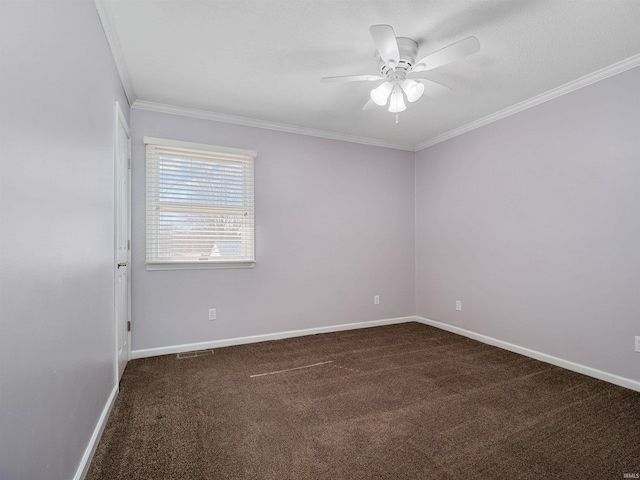 unfurnished room featuring baseboards, dark carpet, ceiling fan, and crown molding