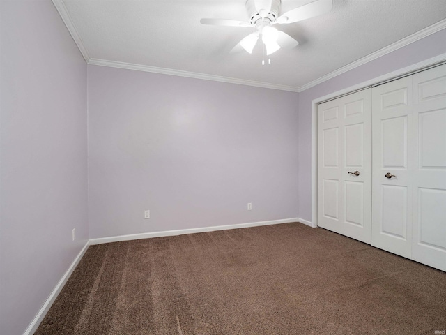 unfurnished bedroom with baseboards, carpet floors, ceiling fan, and crown molding