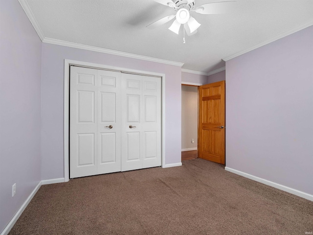 unfurnished bedroom featuring a closet, carpet flooring, baseboards, and ornamental molding