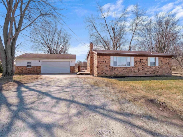 view of property exterior featuring brick siding, a yard, and a garage