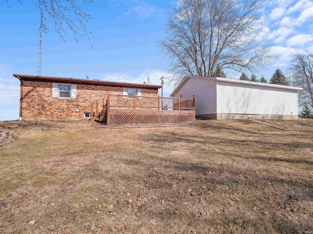 exterior space with a yard, brick siding, and a deck