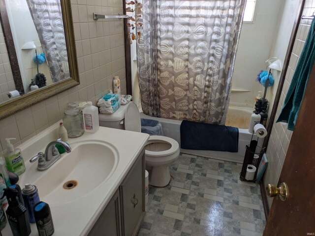 full bathroom with vanity, tile walls, shower / tub combo, and toilet