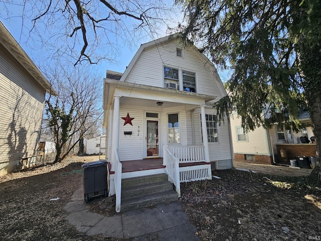 dutch colonial with covered porch and a gambrel roof