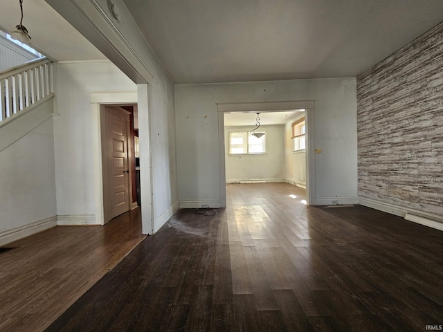 unfurnished room featuring wood finished floors and baseboards