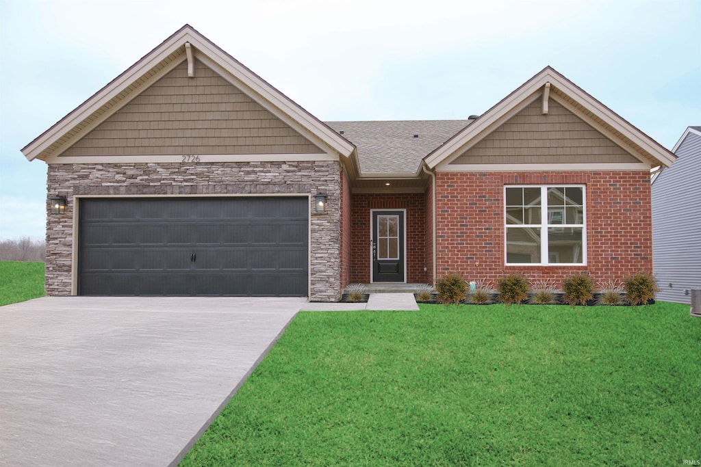 craftsman-style home featuring brick siding, a shingled roof, a front yard, a garage, and driveway