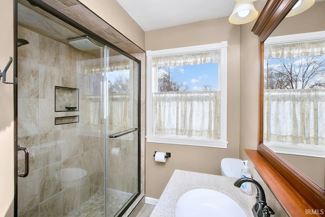 full bath featuring vanity and a shower stall