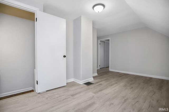 bonus room featuring vaulted ceiling, wood finished floors, visible vents, and baseboards