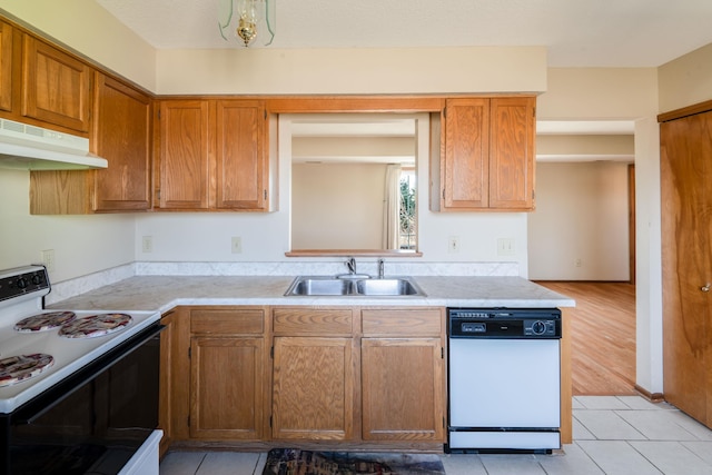 kitchen with under cabinet range hood, light countertops, white dishwasher, electric range, and a sink