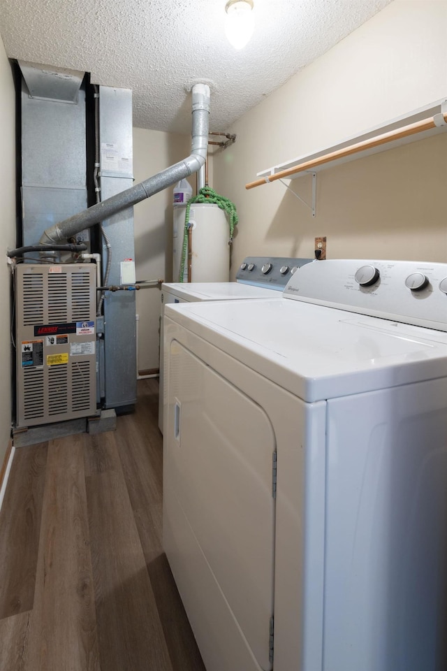 laundry room with gas water heater, laundry area, dark wood-style floors, independent washer and dryer, and a textured ceiling