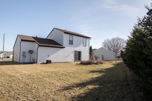 rear view of property featuring a yard