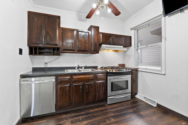 kitchen featuring visible vents, crown molding, under cabinet range hood, stainless steel appliances, and a sink