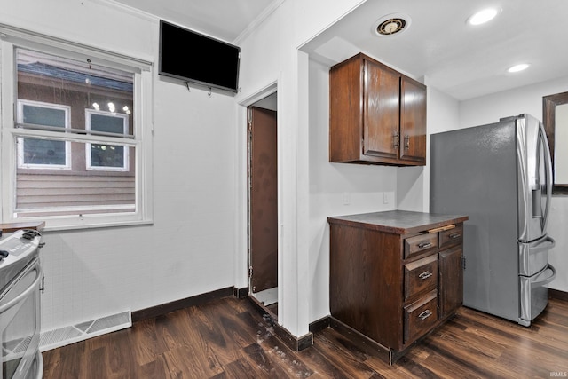 kitchen featuring dark countertops, recessed lighting, appliances with stainless steel finishes, baseboards, and dark wood-style flooring