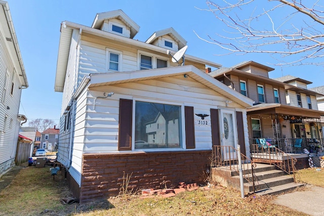 american foursquare style home with a porch