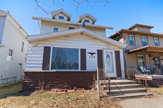 american foursquare style home featuring covered porch