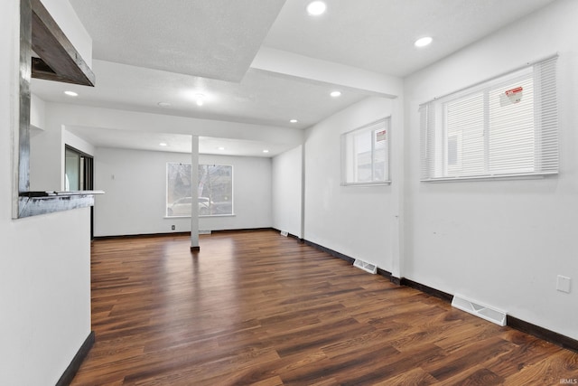 empty room featuring visible vents, recessed lighting, baseboards, and wood finished floors