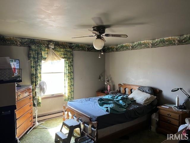 bedroom featuring a baseboard heating unit, a ceiling fan, and light carpet