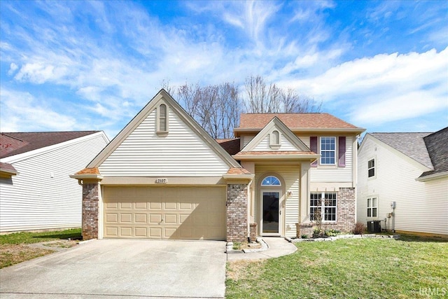 traditional home with brick siding, a front yard, cooling unit, driveway, and an attached garage