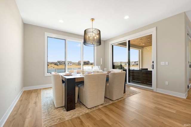 dining space with recessed lighting, baseboards, and light wood-style flooring