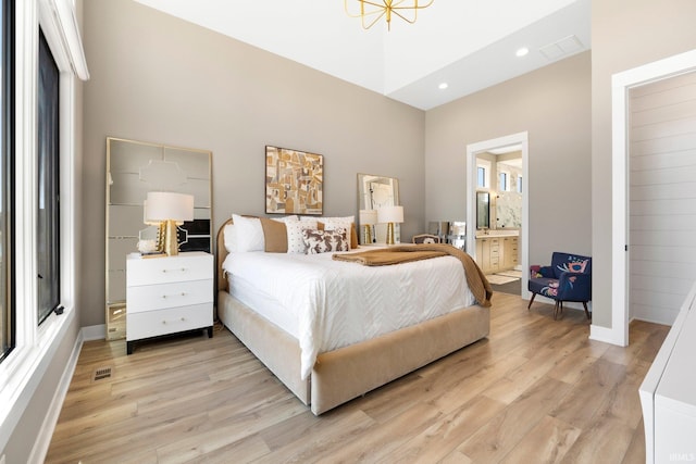 bedroom featuring visible vents, multiple windows, and light wood-style flooring