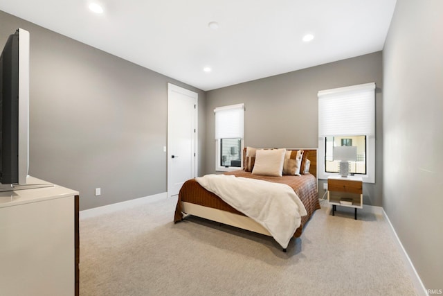 bedroom featuring recessed lighting, baseboards, and light carpet