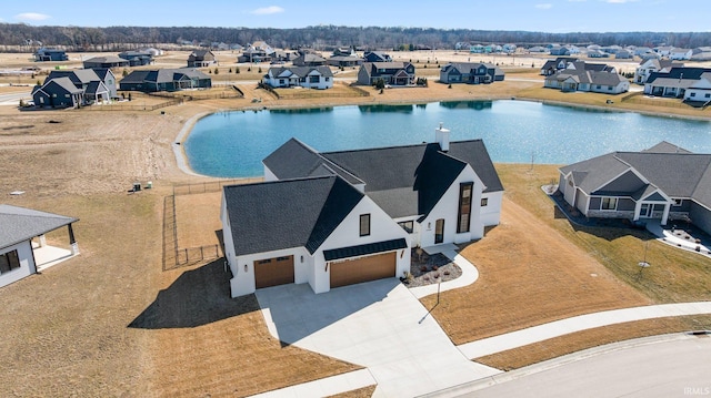 aerial view featuring a residential view and a water view