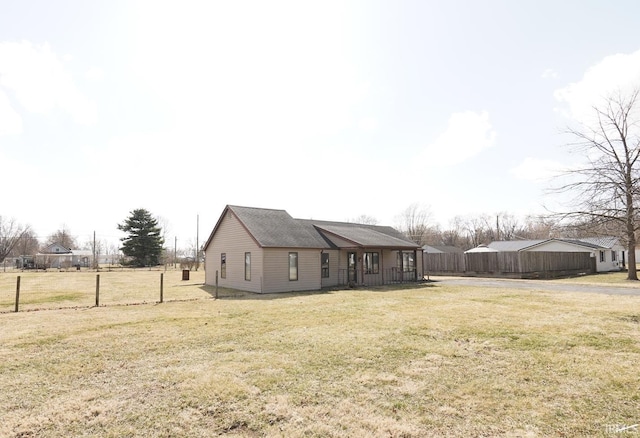 exterior space featuring a yard and fence