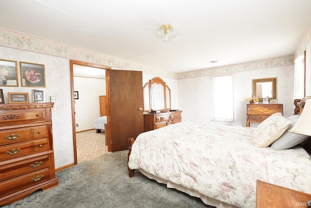 carpeted bedroom featuring baseboards