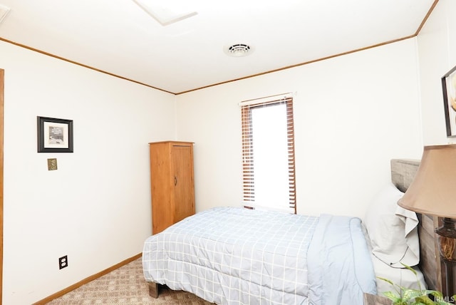 carpeted bedroom featuring visible vents, baseboards, and ornamental molding