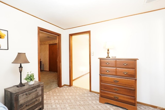 bedroom featuring light carpet and baseboards