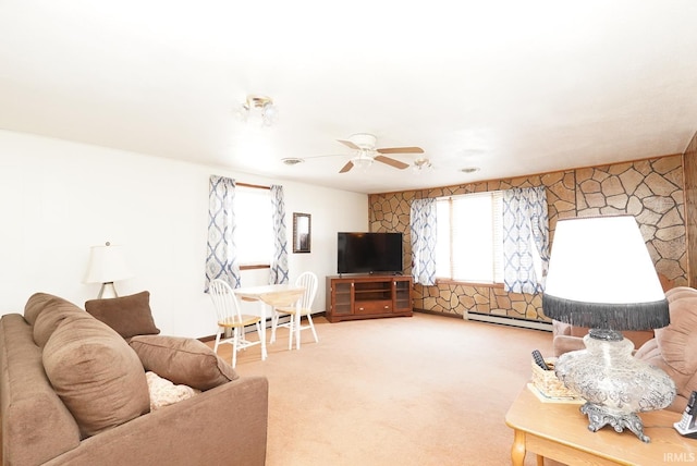 living area featuring baseboard heating, a ceiling fan, and carpet floors