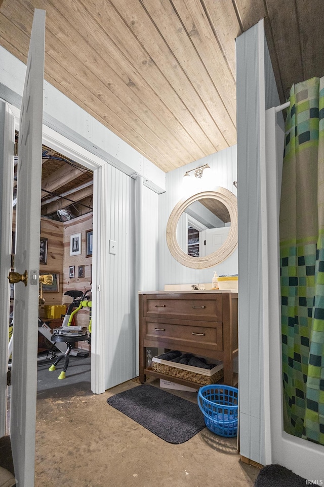 full bathroom with curtained shower, unfinished concrete floors, vanity, and wooden ceiling