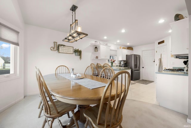 dining space featuring recessed lighting, baseboards, and light floors