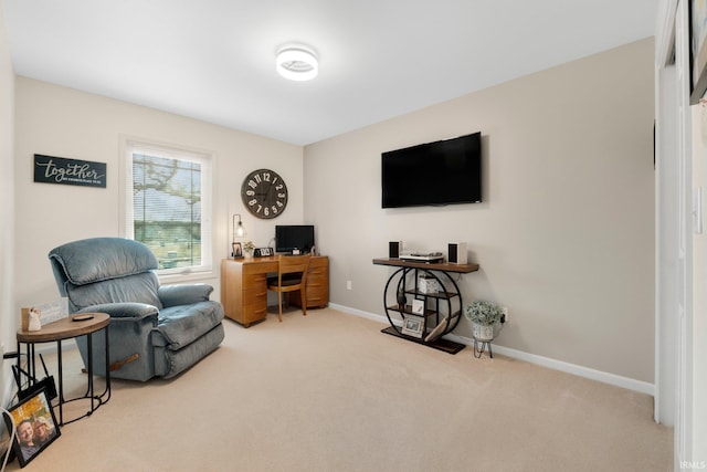 carpeted office space featuring baseboards