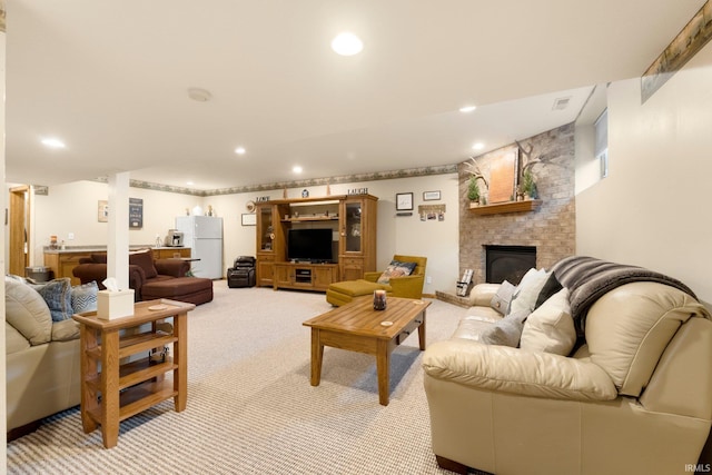 living area featuring light carpet, recessed lighting, and a fireplace