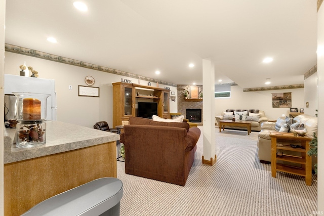 living area featuring recessed lighting, a fireplace, and light carpet