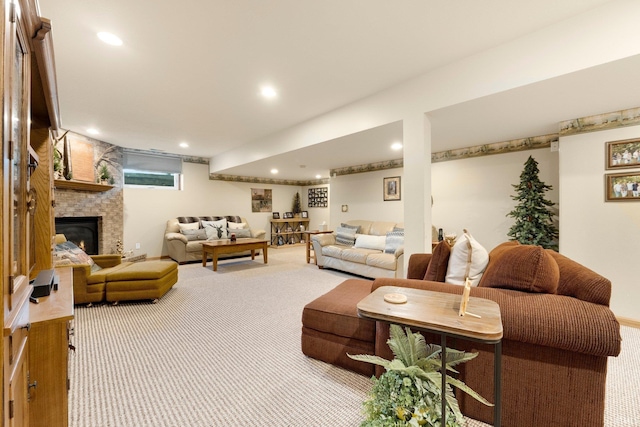 living area featuring a stone fireplace, carpet flooring, and recessed lighting