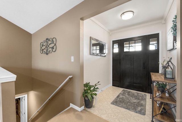 entrance foyer with baseboards and ornamental molding