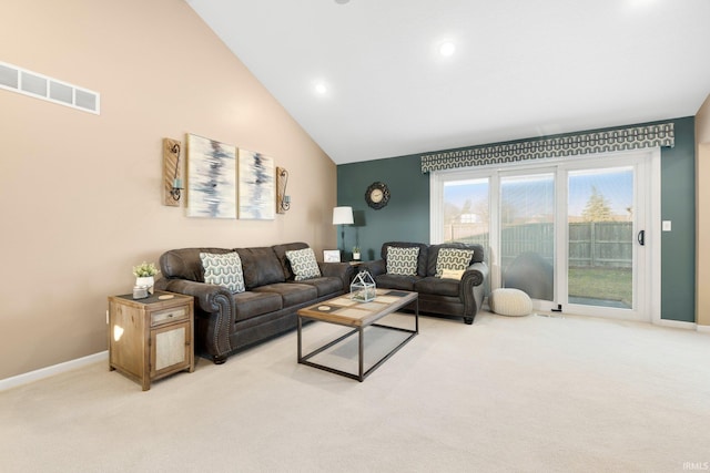 living area featuring visible vents, light colored carpet, high vaulted ceiling, and baseboards