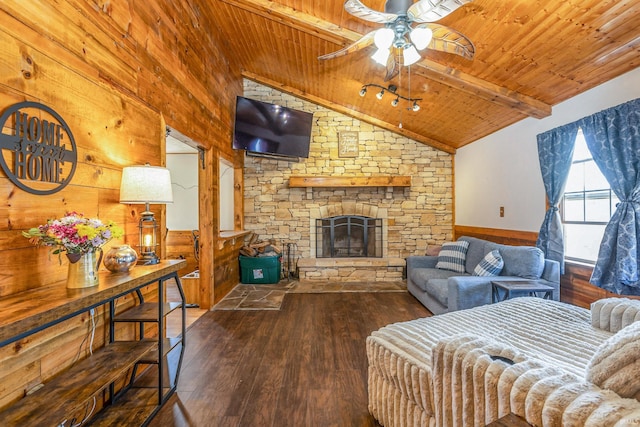 living area with vaulted ceiling with beams, wood ceiling, wainscoting, wood finished floors, and a ceiling fan