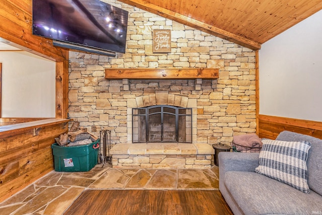 unfurnished living room featuring a wainscoted wall, wood walls, wood ceiling, lofted ceiling, and wood finished floors