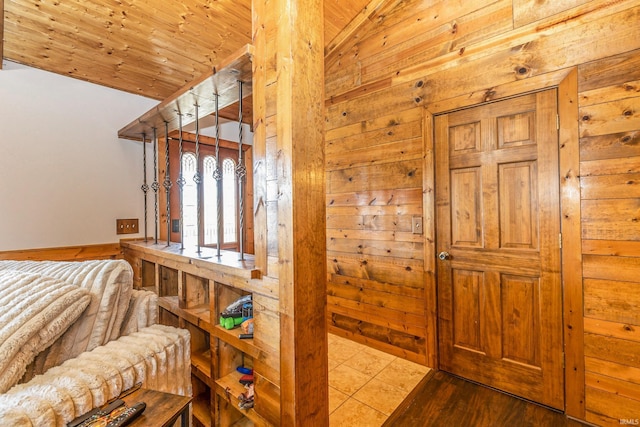 bedroom featuring wooden walls, wood ceiling, wood finished floors, and vaulted ceiling