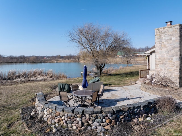 view of yard with a patio and a water view